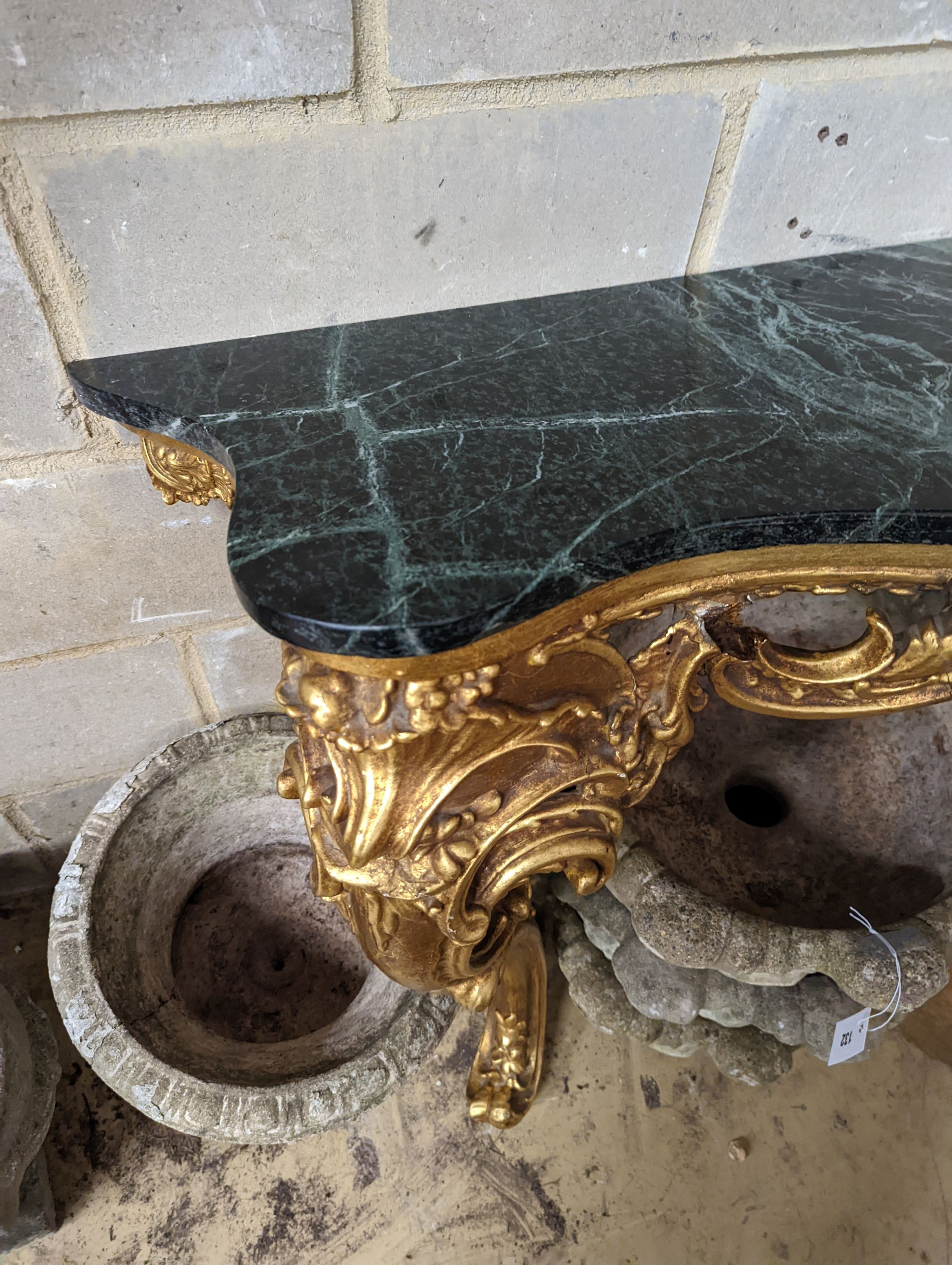 An 18th century style serpentine giltwood marble top console table, width 123cm, height 87cm